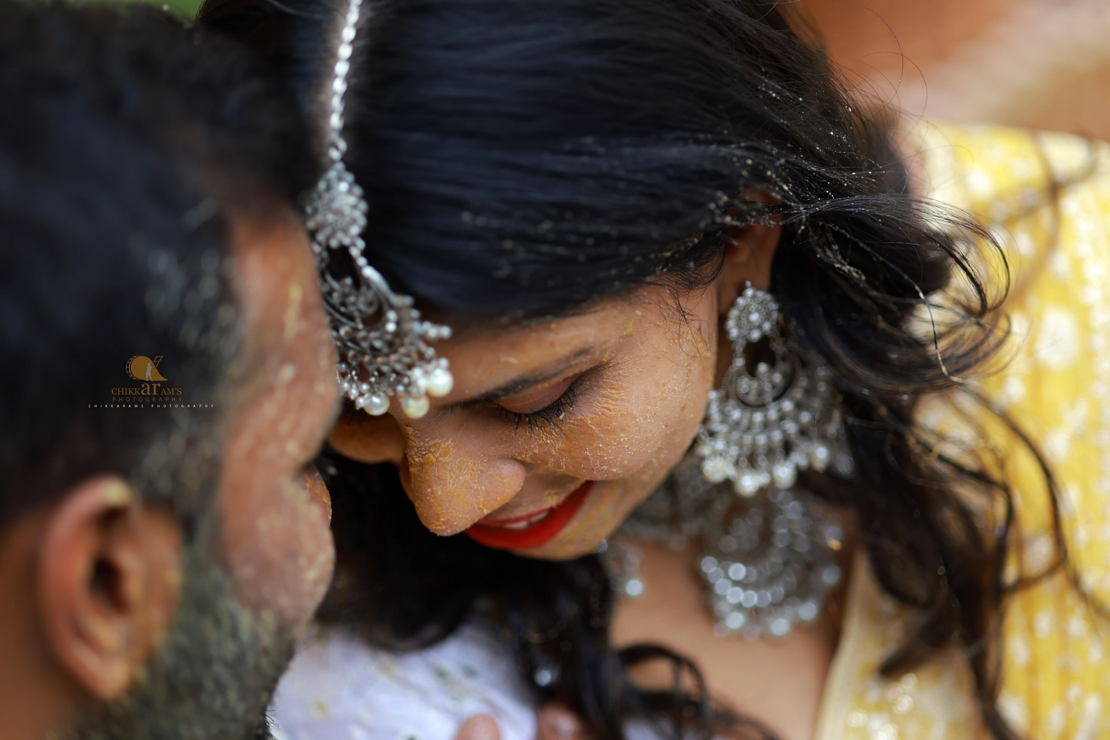 Candid haldi ceremony moment between bride and groom – cinematic portrait captured by Chikkarams Photography